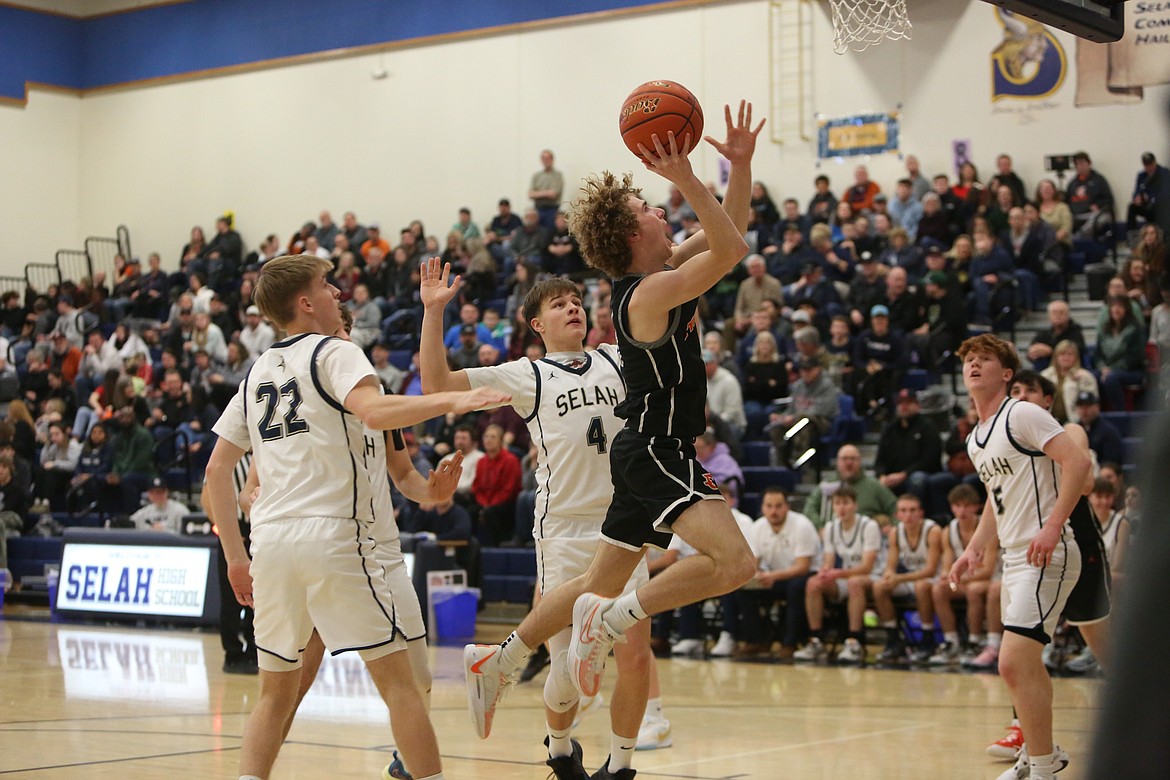 Ephrata junior Payton Riggs, in black, leaps toward the rim in the first half against Selah. Riggs scored 26 points in the game.