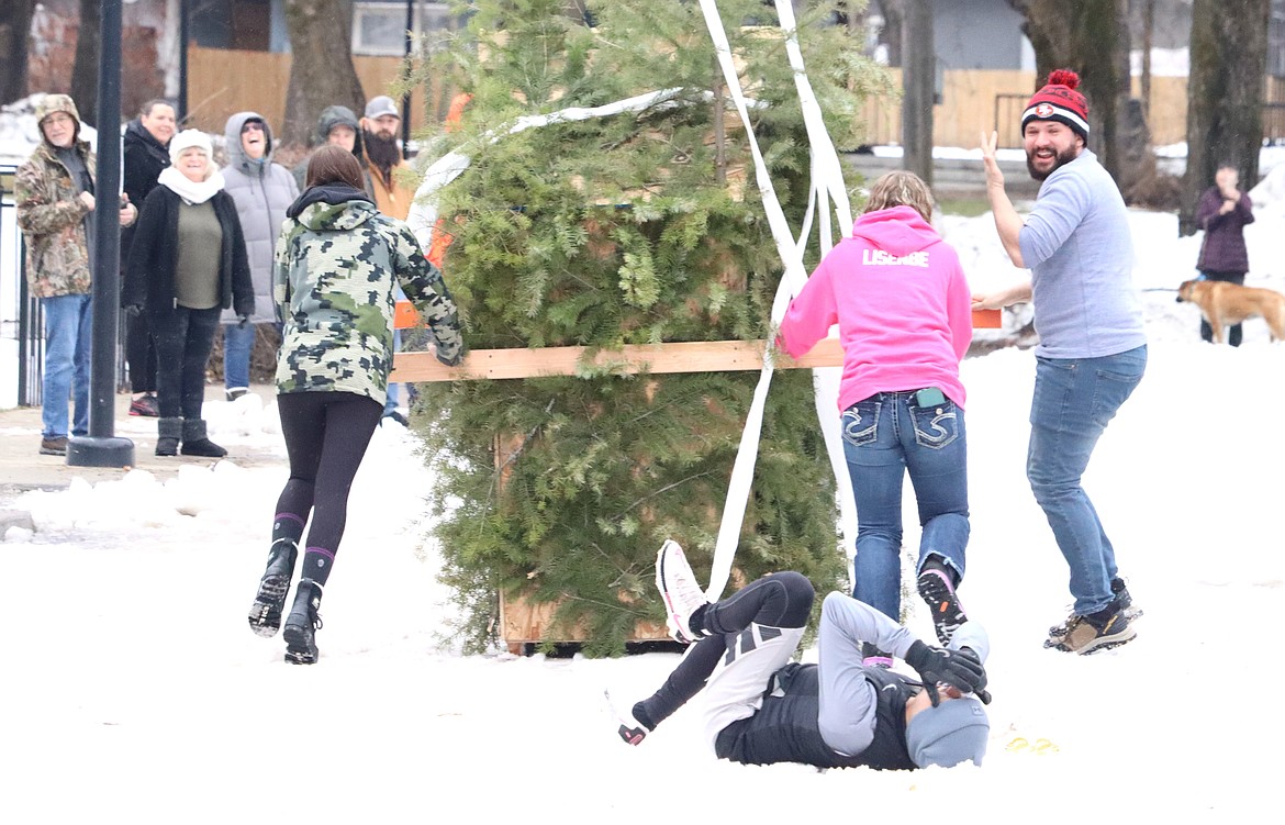 Chris Vignale goes down while brother Joe Vignale looks back in the Winterfest Outhouse Races in Spirit Lake on Saturday.