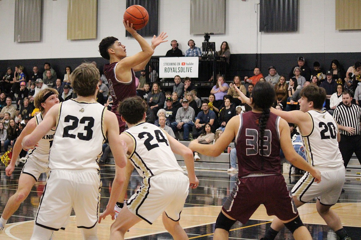 Wahluke’s Diego Perez (4) drives for the basket in the Warrior’s regular season finale against Royal.