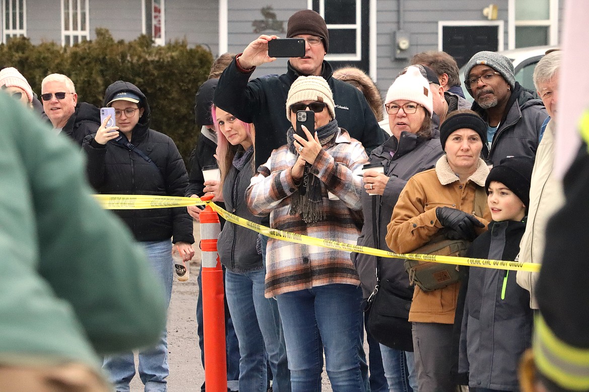 Spectators record the Spirit Lake outhouse races on Saturday.