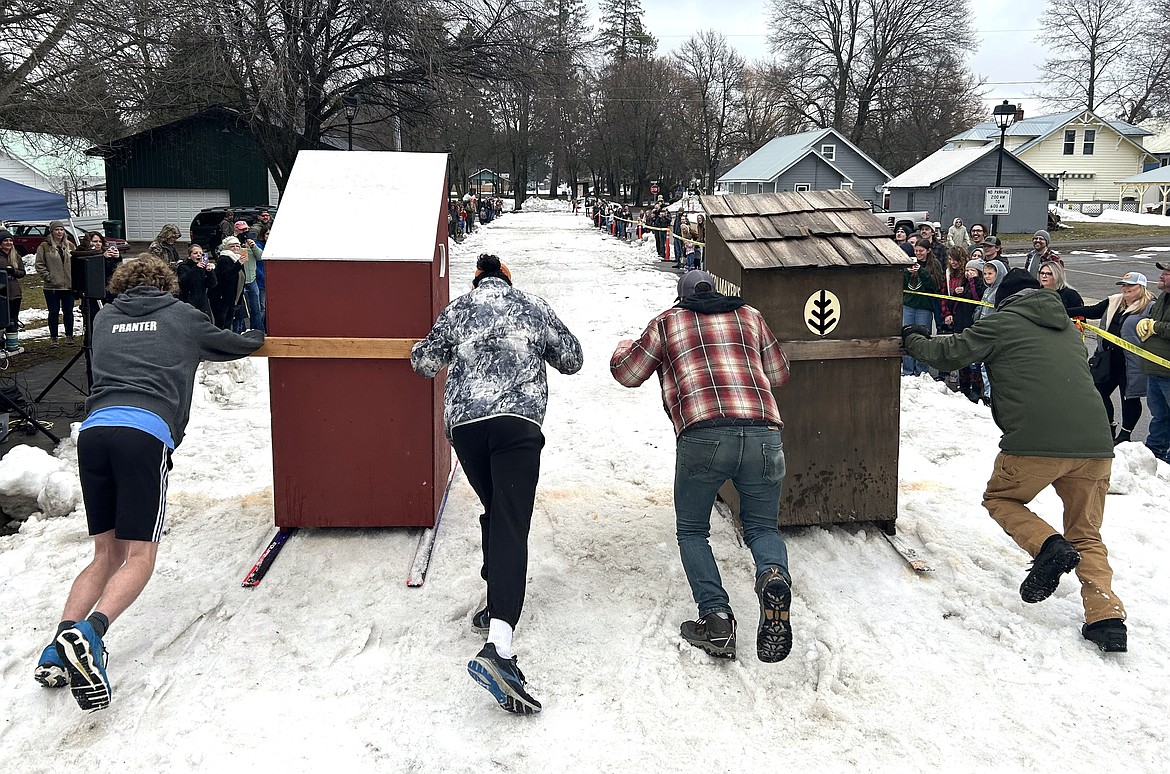 Teams are off at the start of a heat in the Spirit Lake Winterfest Outhouse Races on Saturday.