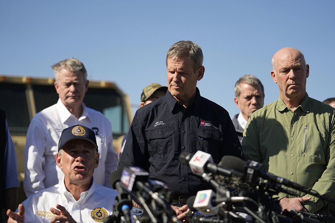 Tennessee Gov. Bill Lee, center, and Montana Gov. Greg Gianforte, right, stand with fellow governors as they listen to Texas Gov Greg Abbott, seated left, during a news conference along the Rio Grande to discuss Operation Lone Star and border concerns, Sunday, Feb. 4, 2024, in Eagle Pass, Texas. Abbott returned to the Eagle Pass border to highlight his escalating attempts to curb illegal crossings on the U.S.-Mexico border. (AP Photo/Eric Gay)