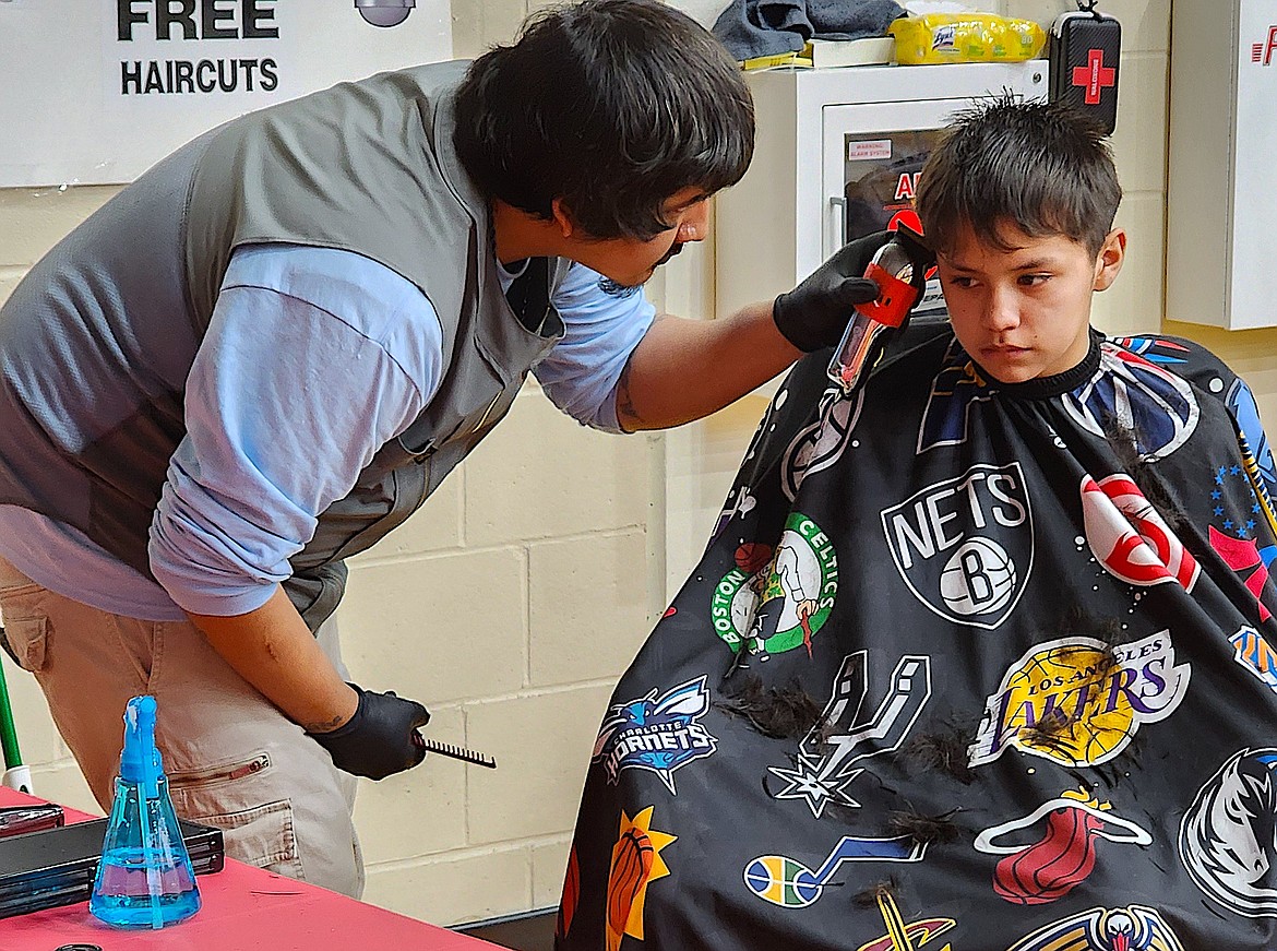 An SKC student who graduated last year was in charge of haircuts at the Baby Fair. (Berl Tiskus/Leader)