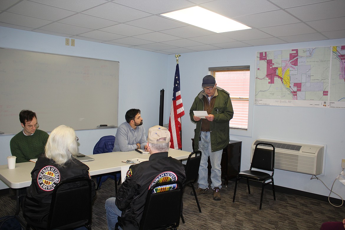 Tim Spangler of Superior reads a letter to two of Sen. Jon Tester’s Missoula field representatives, Arthur Pettit (left) and Shibu Arens as Linda and Ron Forest listen. (Monte Turner/Mineral Independent)