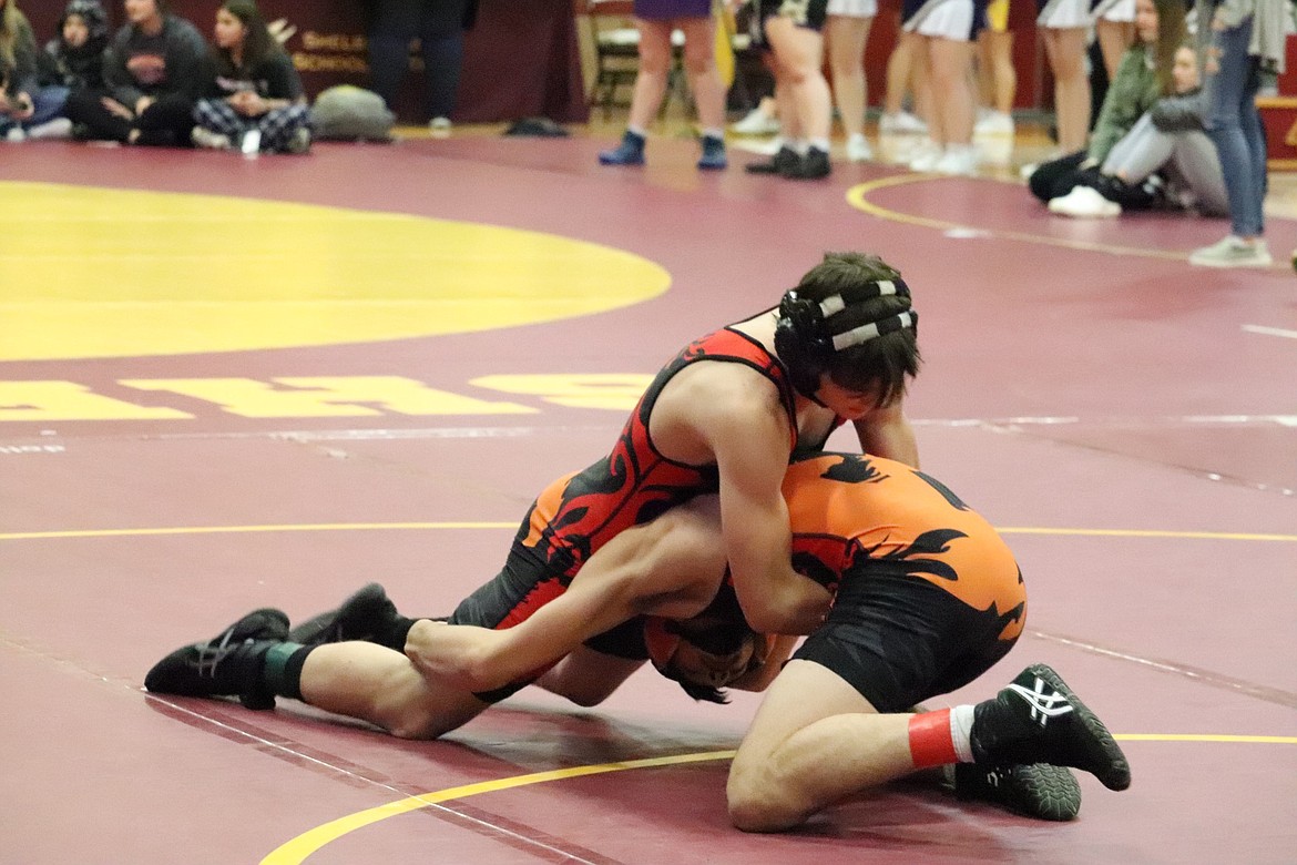 Plains/Hot Springs wrestlers Drew Carey, red band on ankle, and Beau Crabb battle it out for the 138-pound individual title during the Western Division B-C wrestling championship in Shelby this past weekend.  Carey placed first and Crabb took second as both advanced to the state finals next week in Billings. (Photo by Kami Milender)