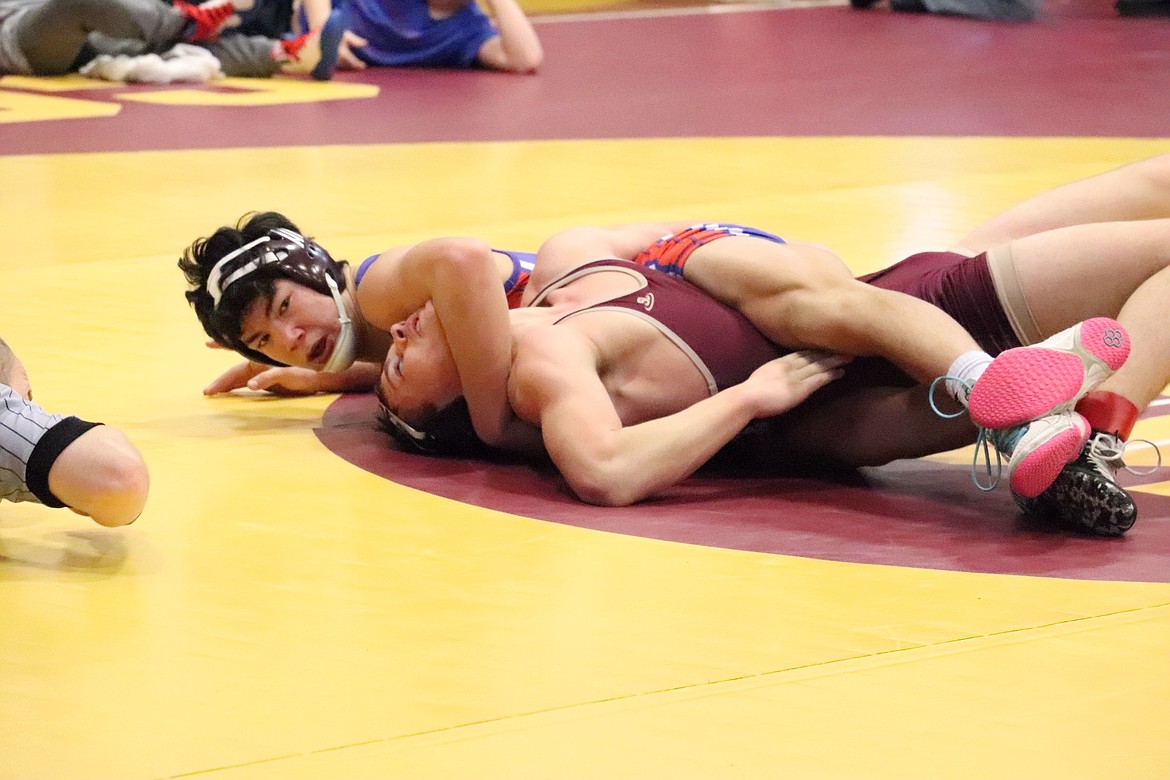 Superior 152 pounder Lucas Kovalsky, top, nears a pin of this opponent during this past weekend's Western Division B-C wrestling tournament in Shelby.  Kovalsky finished third and earned a trip to the state championships next weekend in Billings. (Photo by Kami Milender)