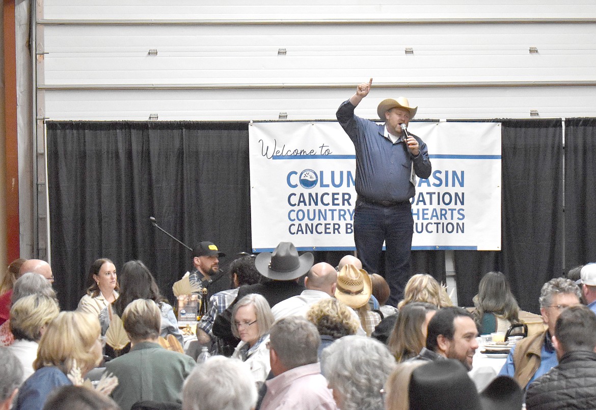 Auctioneer Chuck Yarbro Jr. kicks off the live auction at the 15th annual Country Sweethearts Benefit Auction Saturday. The event raised more than $318,000 for the Columbia Basin Cancer Foundation.