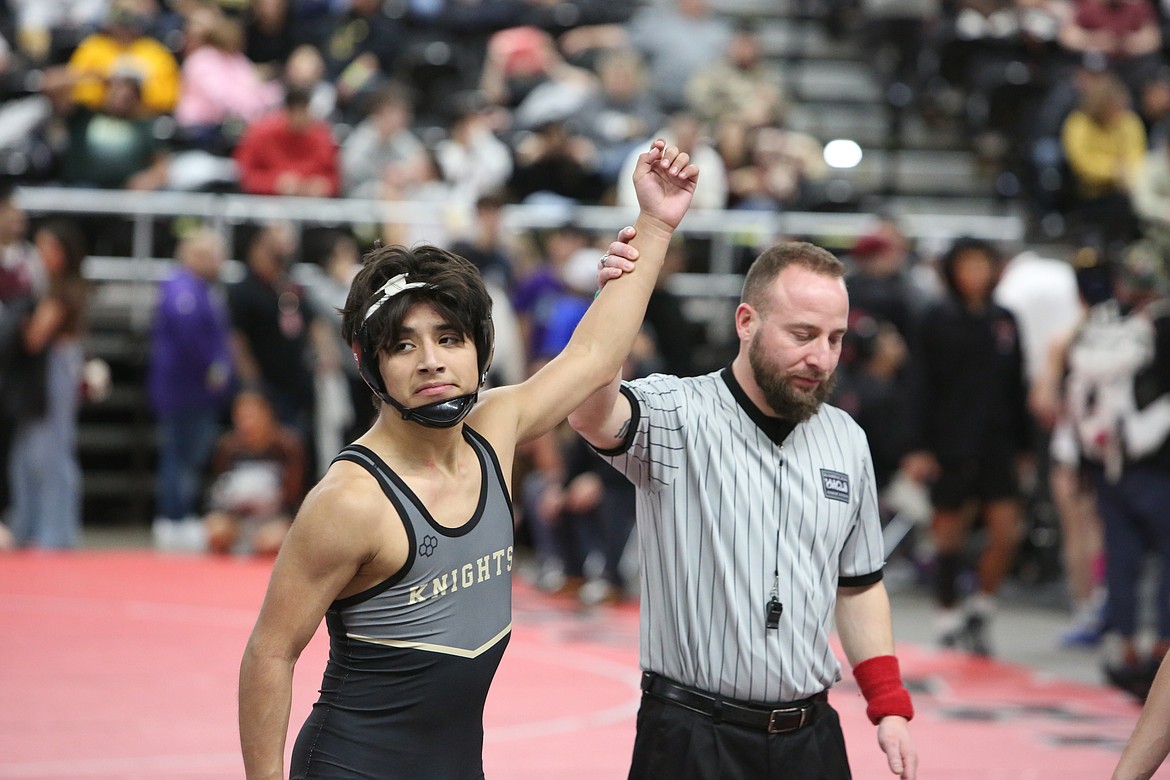 Royal sophomore Dennis Hernandez, left, won the 113-pound bracket of Friday’s South Central Athletic Conference (East) district tournament.