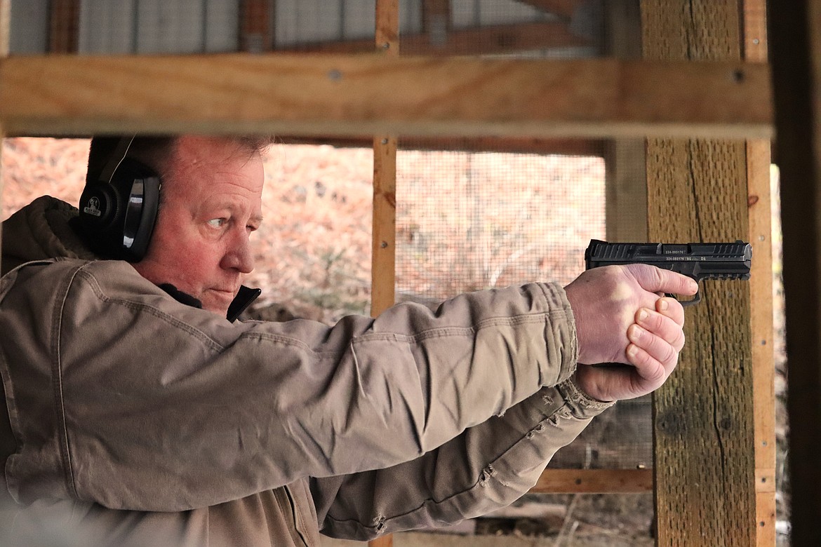 Nate Pulliam, range safety officer at the Coeur d'Alene Rifle and Pistol Club, takes aim at the outdoor range.