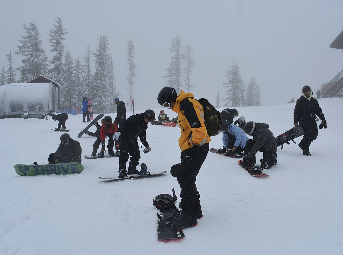 Jaden Satter steps into his rented gear during the Fairchild Air Force Base's Snowfest event at Silver Mountain Resort. "It was fun, I fell about 18 times," Satter said after his first snowboarding run down the slope.