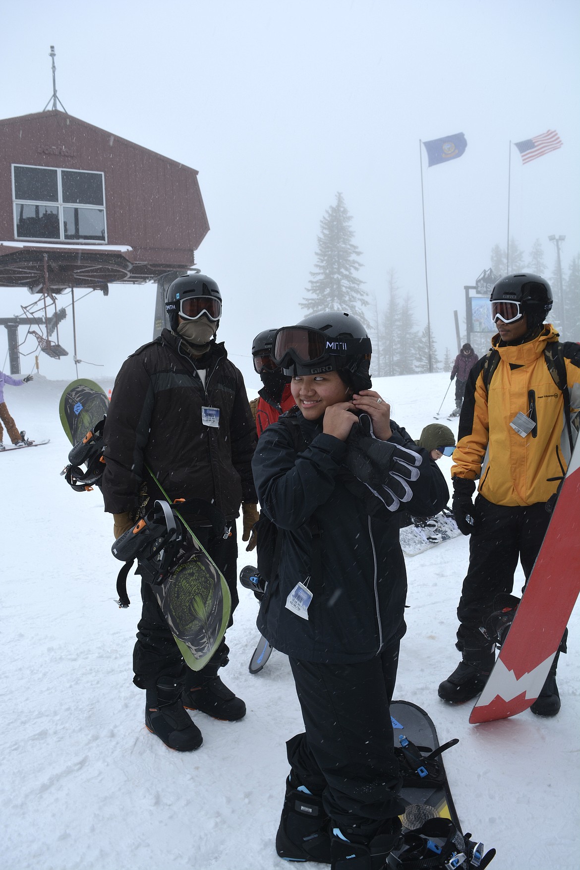 Janela Nunsinge snaps her helmet into place before snowboarding down the slopes at Silver Mountain Resort. She works on the supply team at Fairchild Air Force Base.