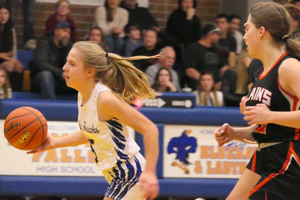 Thompson Falls guard Solveig Nygaard dribbles past Plains defenders on her way to the hoop during Thursday's game in Thompson Falls. (Chuck Bandel/VP-MI)