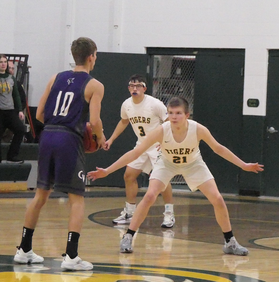 St. Regis guard/forward Colton Todd defends against Charlo senior Hayden Hollow (10) during their game Friday night in St. Regis, won by the Tigers 67-44. (Chuck Bandel/MI-VP)