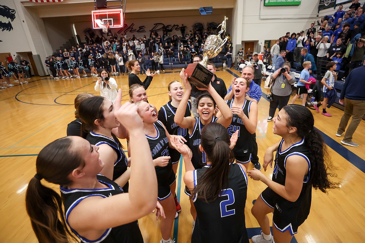 JASON DUCHOW PHOTOGRAPHY
Coeur d'Alene High senior Teagan Colvin, center, hoists the 5A Region 1 girls basketball championship trophy after the Vikings' 50-31 win over Lake City in the championship game on Tuesday at Lake City High.