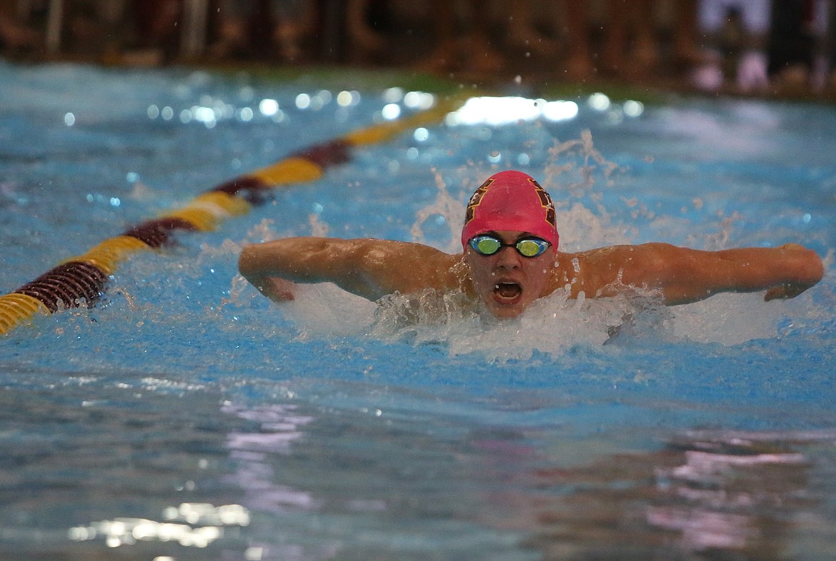 Moses Lake junior Luke Molitor swims during the preliminarily round of the 100-yard butterfly Thursday.