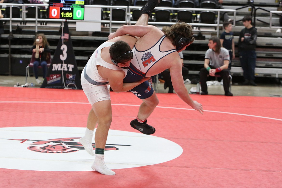 Othello junior Anthono Solorio, left, takes down Ellensburg’s Deklin Graham, right, in the 215-pound finals of Friday’s Central Washington Athletic Conference tournament.