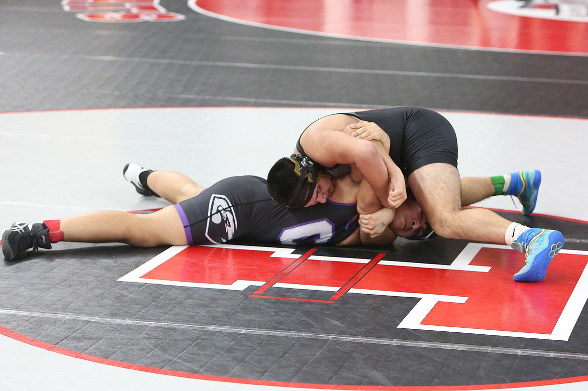 Royal junior David Romero, right, wrestles during Friday’s South Central Athletic Conference (East) district tournament in Yakima.