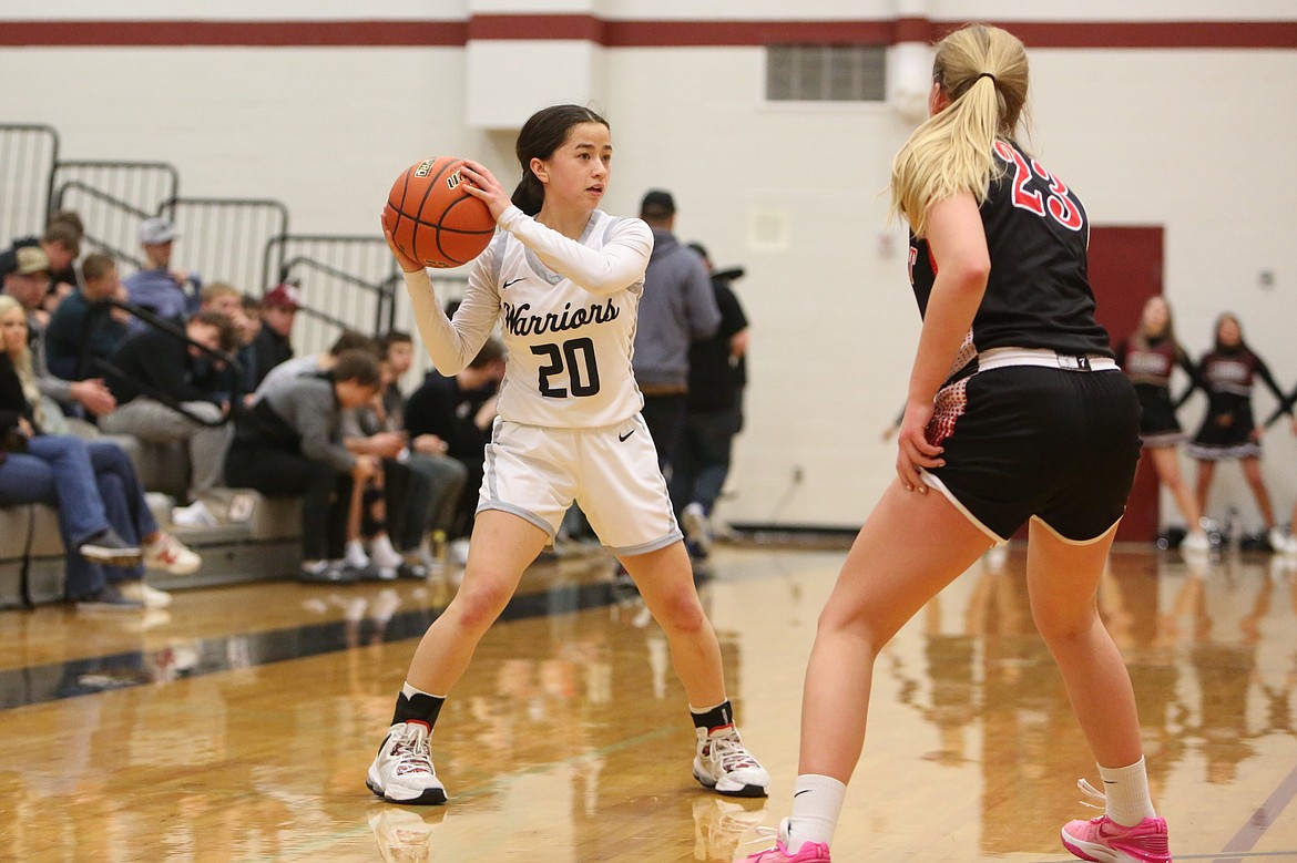 ACH senior Beth Okamoto (20) looks for a teammate to pass the ball to in the second quarter of the Warrior’s district tournament win over Northport.