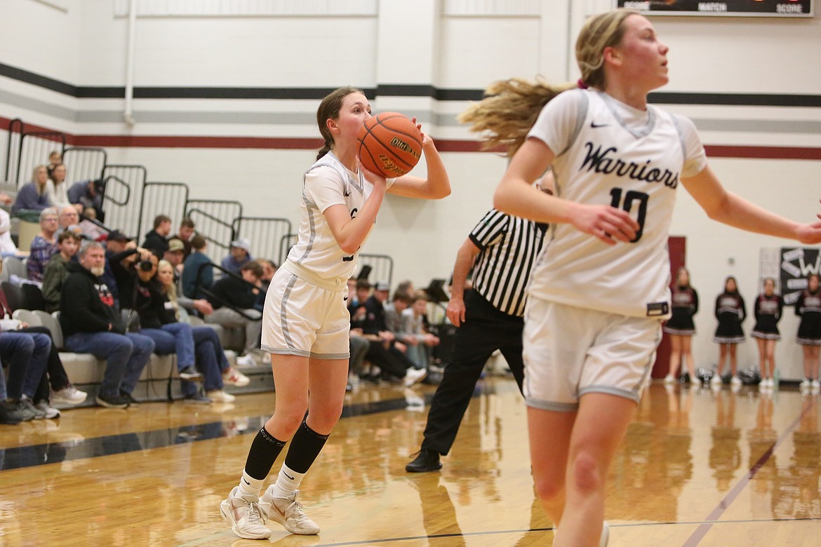 ACH sophomore Emma Whitaker, left, attempts a three-pointer in Tuesday’s win over Northport.