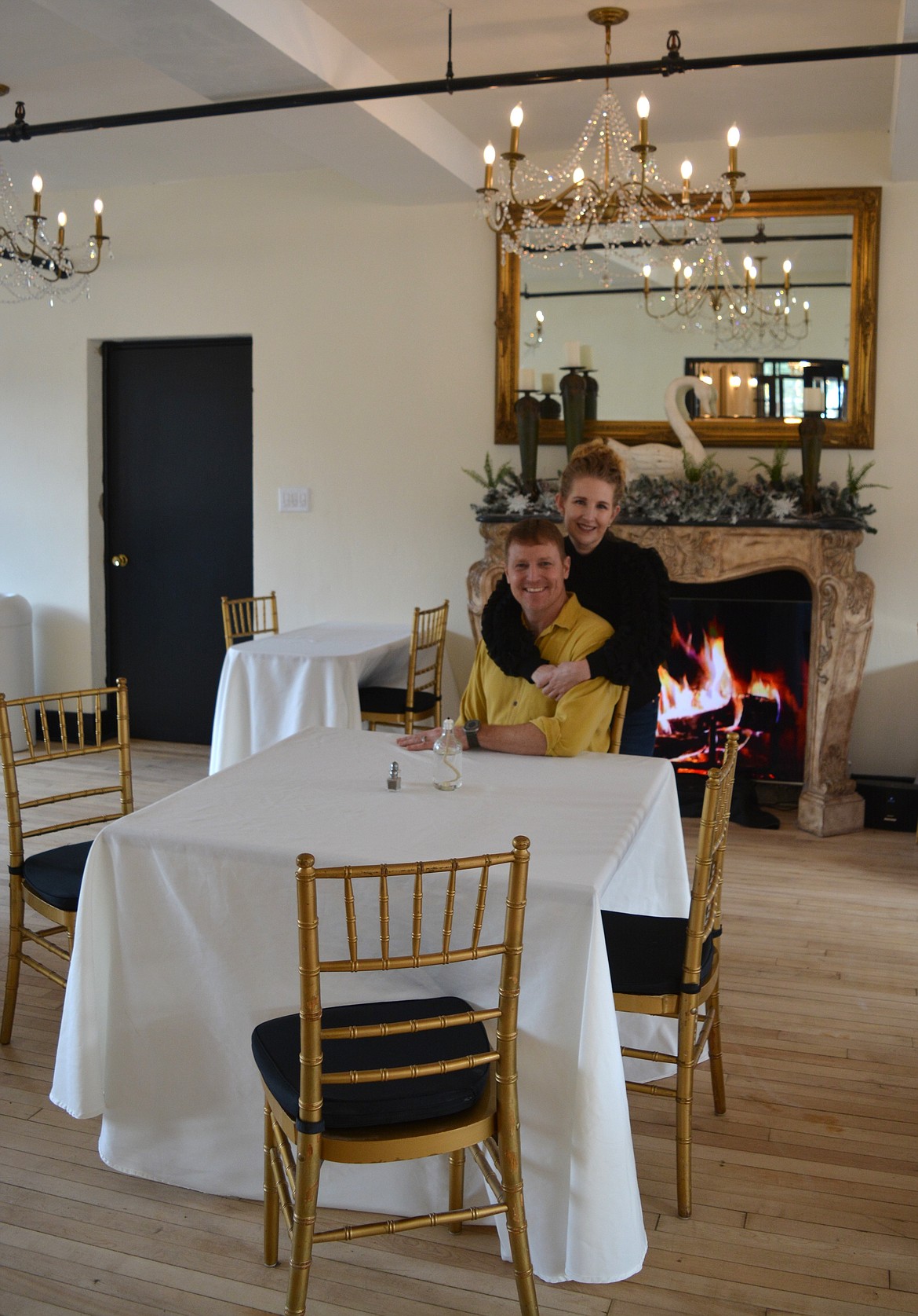 Elizabeth and Gerald Allison stand in front of the digital fireplace at Silverton Mountain Manor. The two began opening hotel rooms one by one in mid-2023 and opened the restaurant in November.