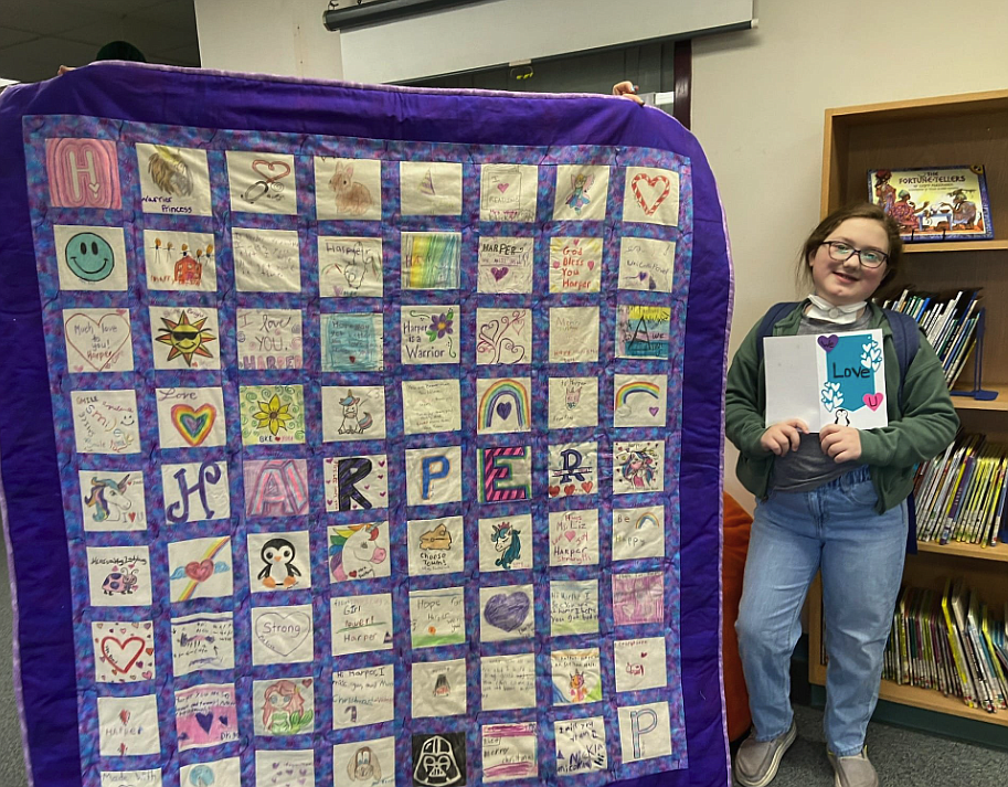 Harper Pursley in seen in spring 2023 with a quilt made by her classmates and teachers at Betty Kiefer Elementary School. Harper, 11, died Feb. 1 after a six-year battle with ROHHAD syndrome, an ultra rare disorder that affects multiple systems in the body.