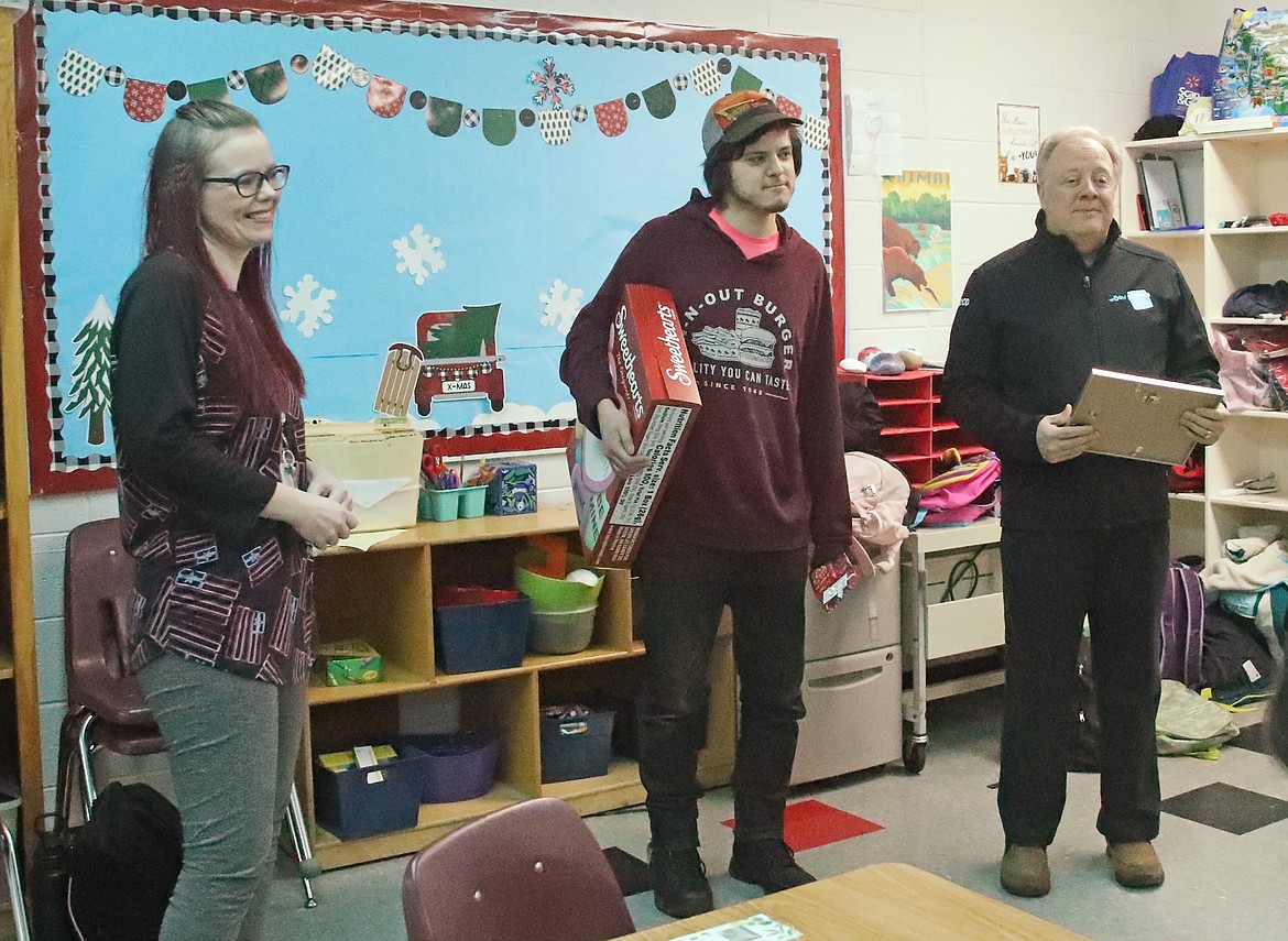 Jennifer Nixon smiles after being surprised as a School Hero by her son, Joshua Mata, and Idaho Lottery spokesman David Workman. Nixon was nominated for the award by her son, who cited her hard work and dedication to her students.