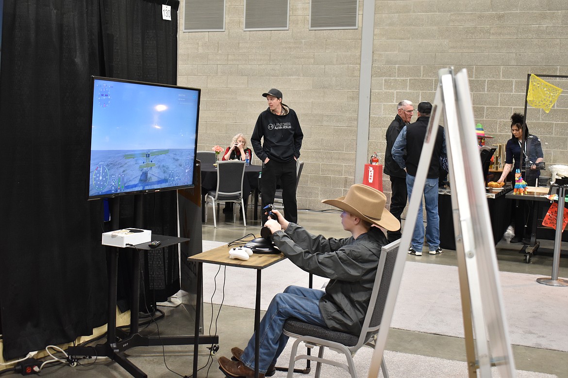 Jett Cobb makes landing a simulated crop duster look easy at the Spokane Ag Show Wednesday. His dad, Farmland Company owner Tim Cobb, set up the simulator as part of the display for his farm management service.