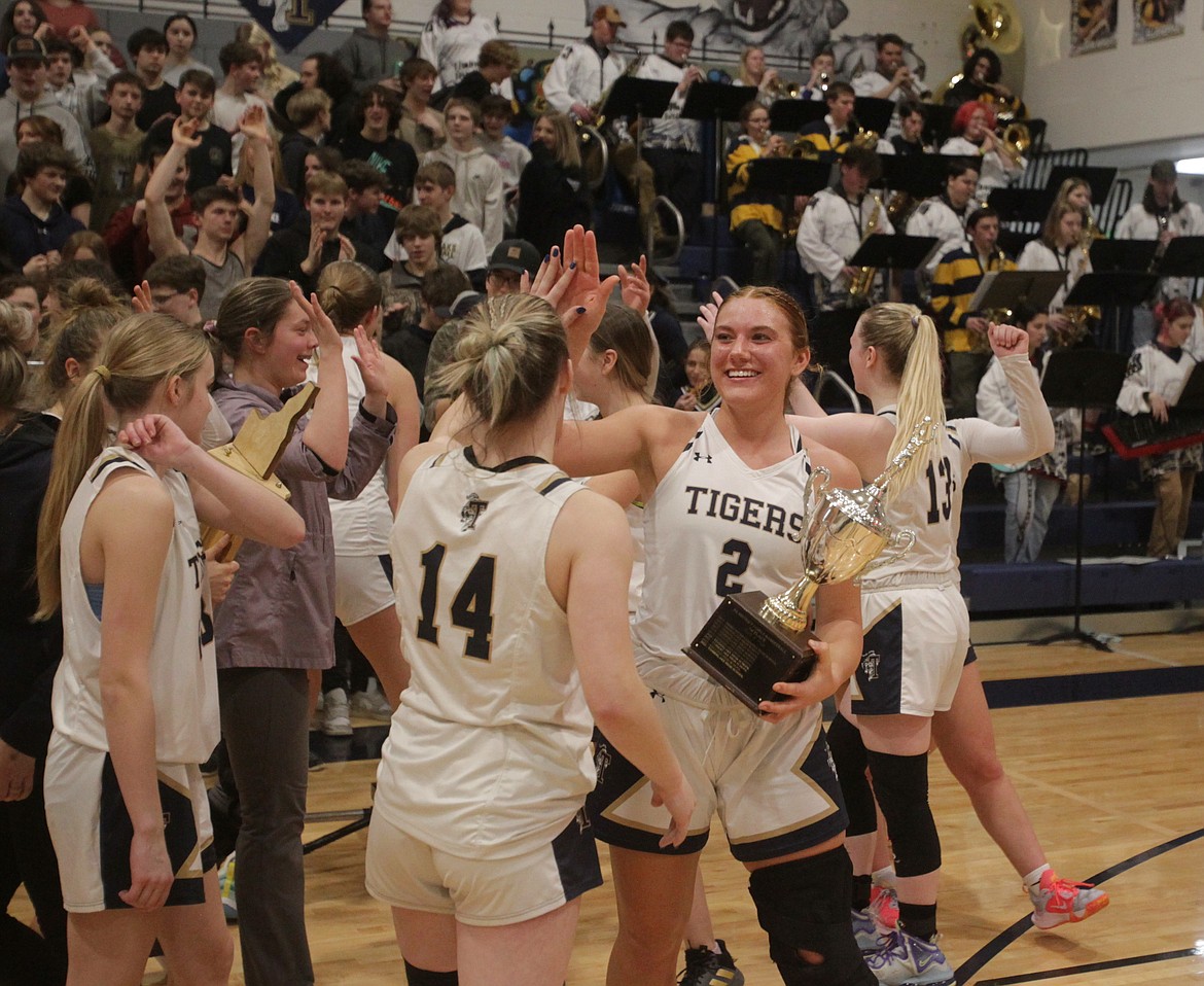 MARK NELKE/Press
Senior Morgan Dickinson (2) celebrates with some hardware after Timberlake won the 3A District 1 girls basketball tournament, beating Bonners Ferry on Thursday night in Spirit Lake.