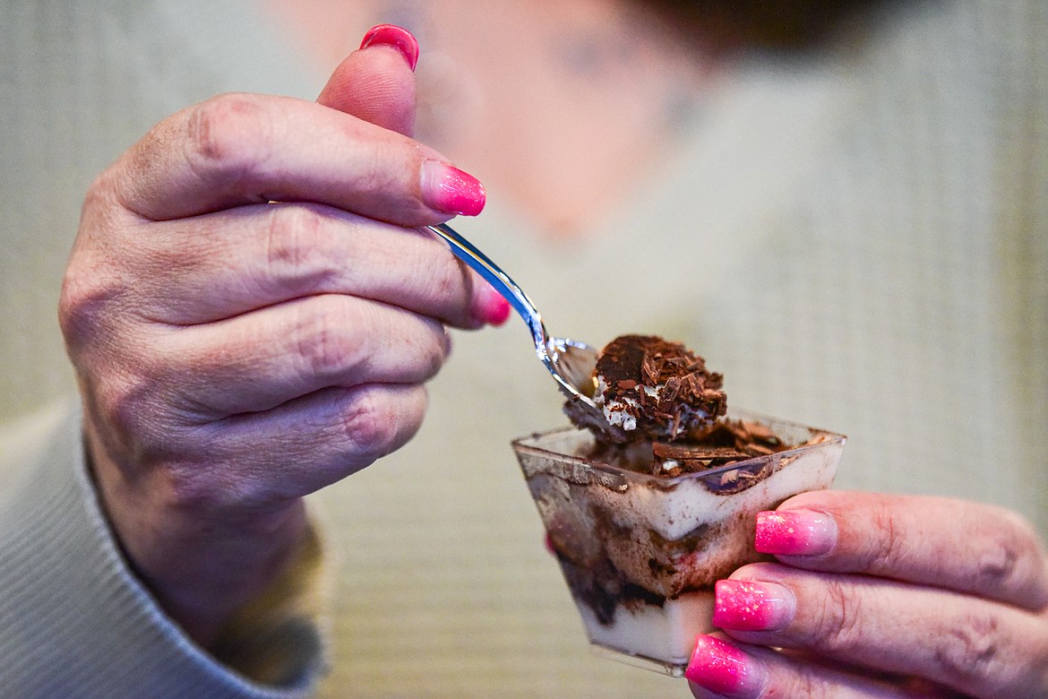 A visitor eats a spoonful of Zinfandel infused tiramisu at MontaVino Winery during the 2024 Chocolate Affair in downtown Kalispell on Friday, Feb. 9. (Casey Kreider/Daily Inter Lake)