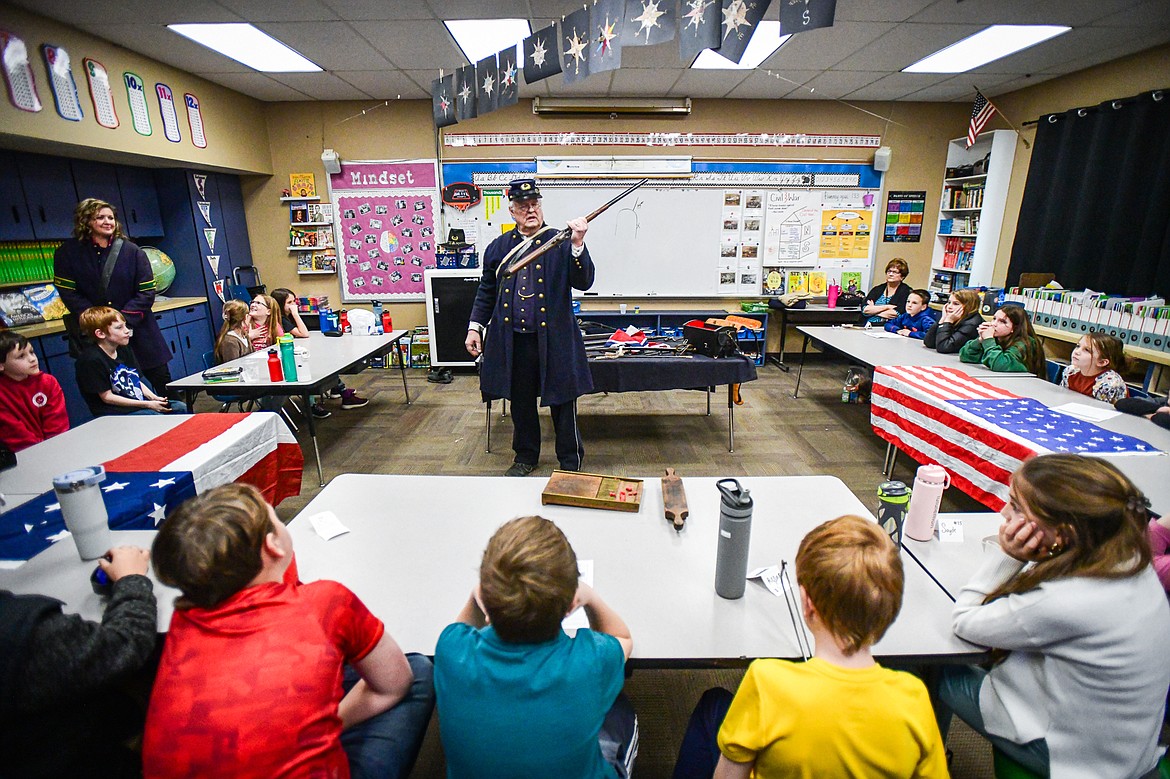 Civil War reenactor and historian Mike Inman shows a Sharps carbine rifle to Karissa Prewitt's fourth-grade class at Peterson Elementary School in Kalispell on Friday, Feb. 9. (Casey Kreider/Daily Inter Lake)