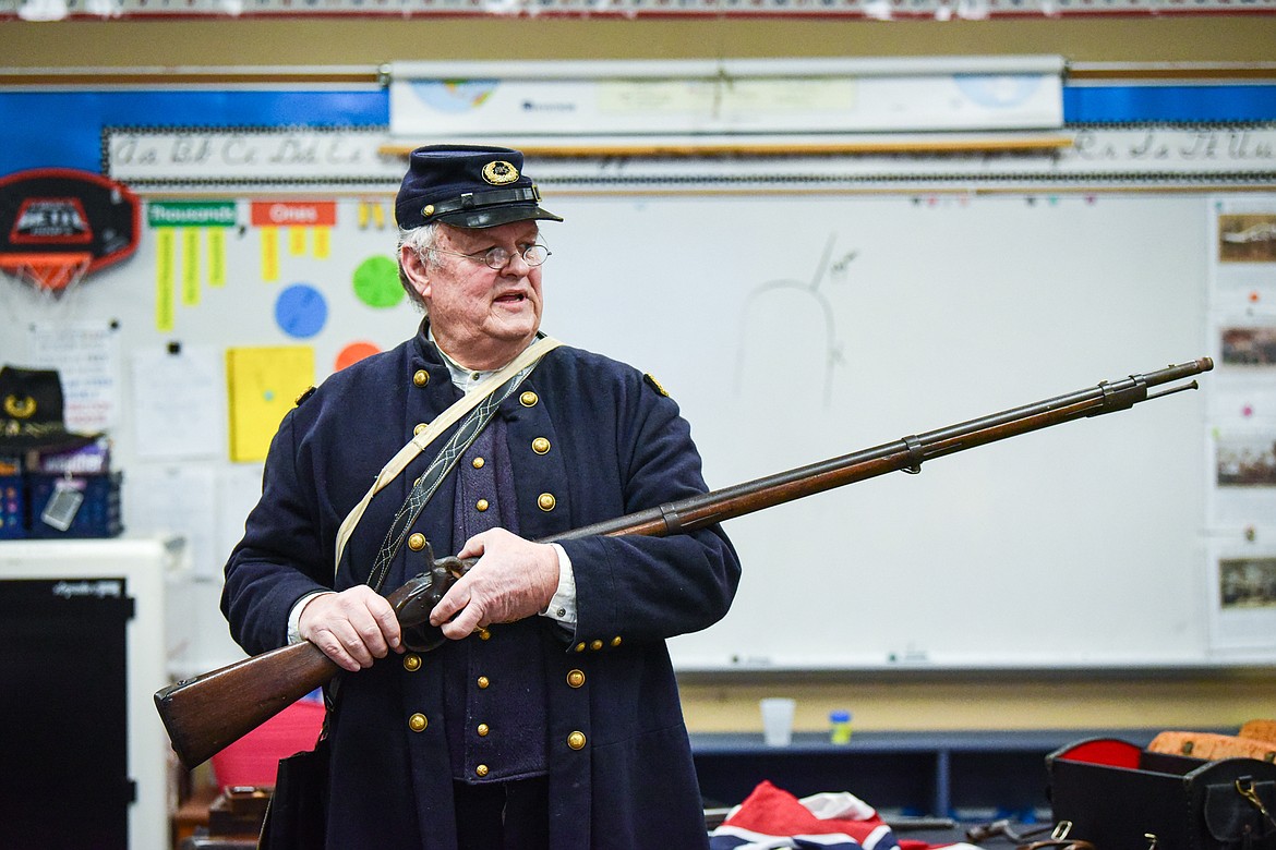 Civil War reenactor and historian Mike Inman shows a musket to Karissa Prewitt's fourth-grade class at Peterson Elementary School in Kalispell on Friday, Feb. 9. (Casey Kreider/Daily Inter Lake)