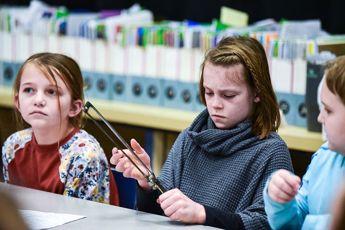 Fourth-grade students pass around a Civil War-era bone saw during a lesson by reenactor and historian Mike Inman in fourth-grade teacher Karissa Prewitt's class at Peterson Elementary School in Kalispell on Friday, Feb. 9. (Casey Kreider/Daily Inter Lake)