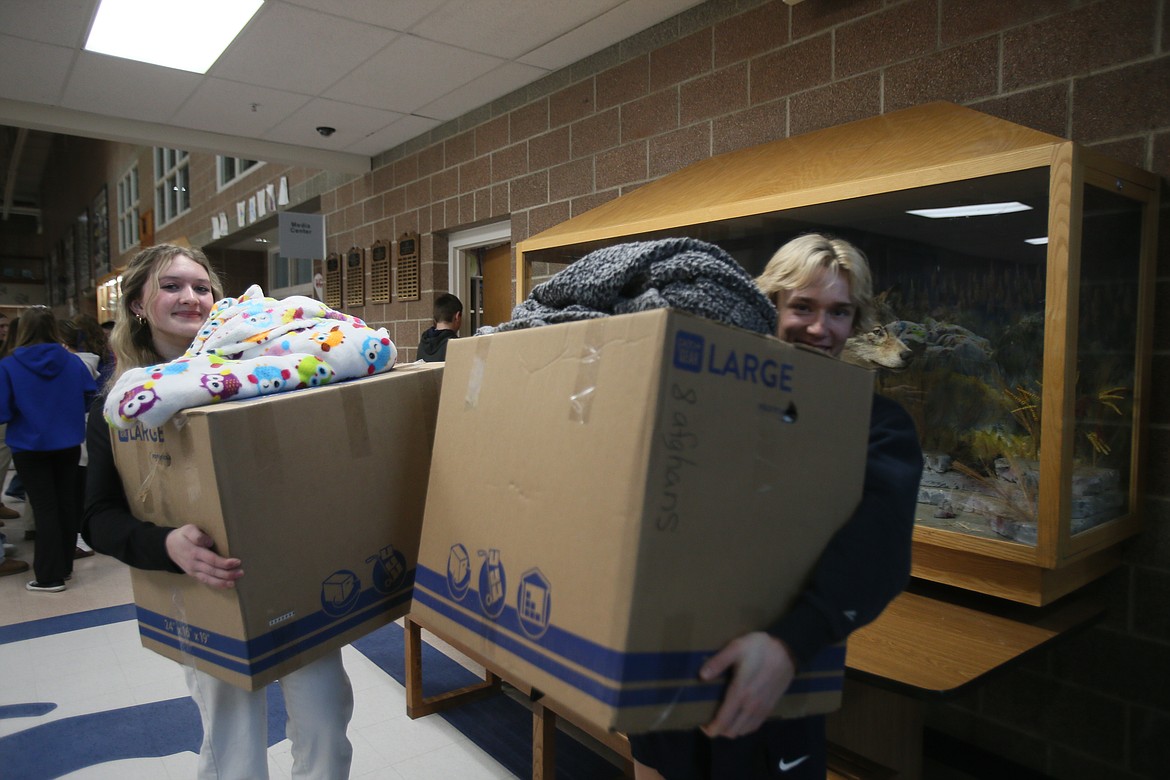 Lake City High freshmen Jami Williams and Decker St. John carry items out to their cars for delivery Friday as the 2024 All for Awl program concludes. Students at Coeur d'Alene and Lake City high schools spent weeks gathering funds and needed items to support community nonprofits such as Children's Village and Union Gospel Mission.