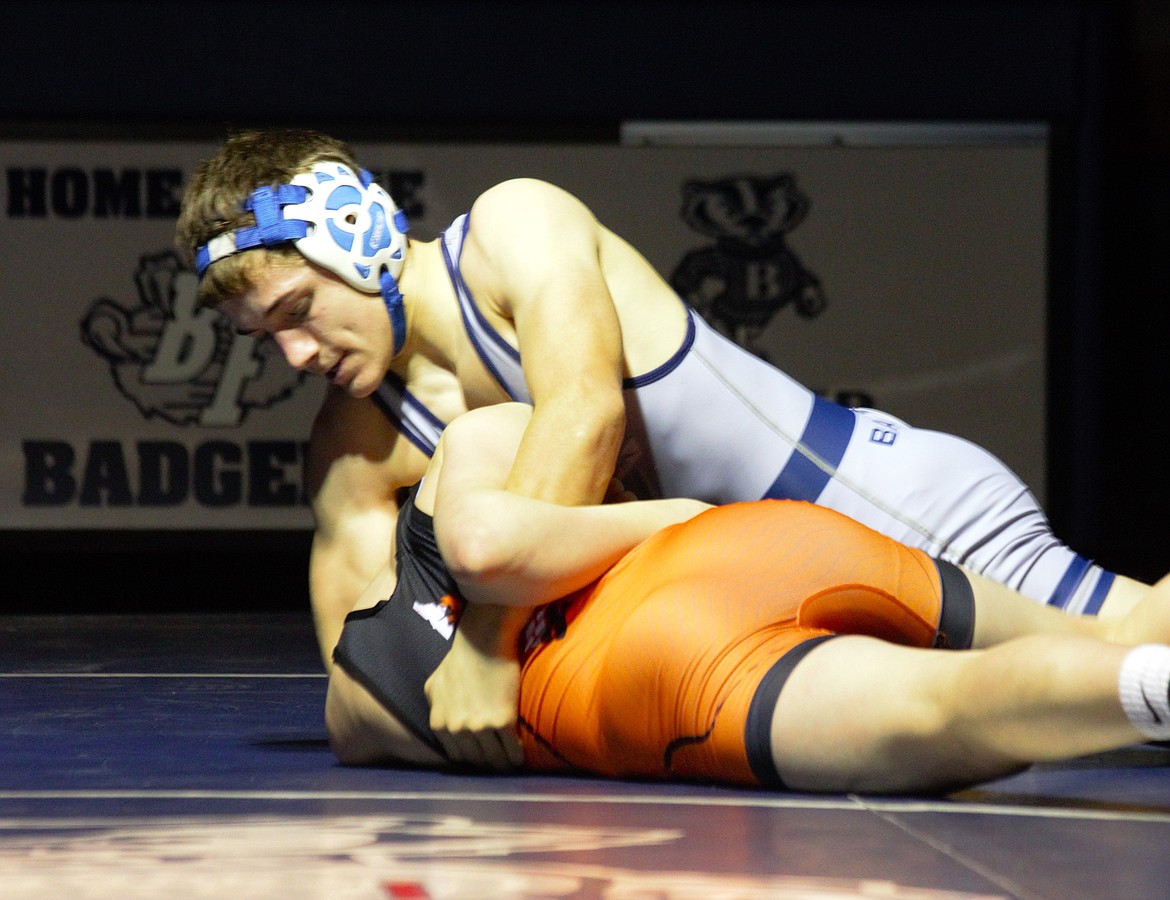 Saber Blackmore (113) takes control of the match against his Post Falls opponent on Feb. 7.