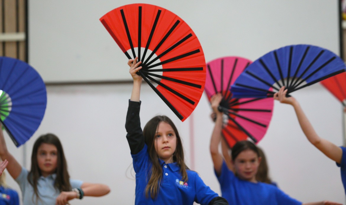 Fourth grader Laney Hobson and her classmates perform a Japanese fan dance Friday at Sorensen Magnet School of the Arts and Humanities.