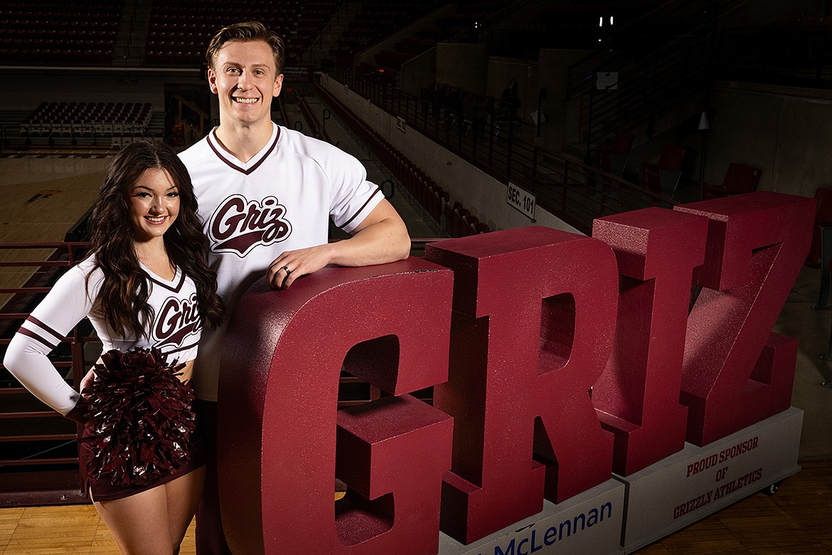 University of Montana students Annika and Wyatt Smith combine their love for each other as a married couple with their love for the University cheer squad, performing carefully coordinated stunts at many sporting events. (UM photo by Ryan Brennecke)