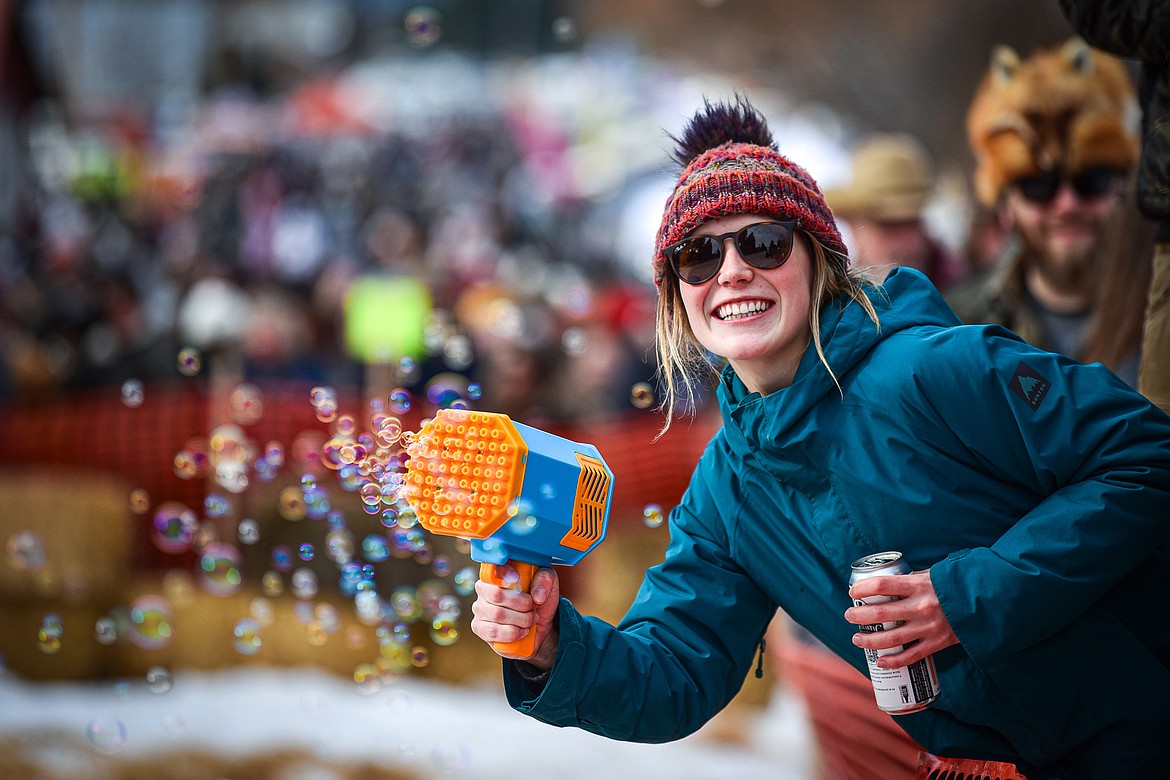An attendee uses a  bubble gun at the finish line at the Barstool Ski Races at Cabin Fever Days in Martin City on Saturday, Feb. 10. (Casey Kreider/Daily Inter Lake)