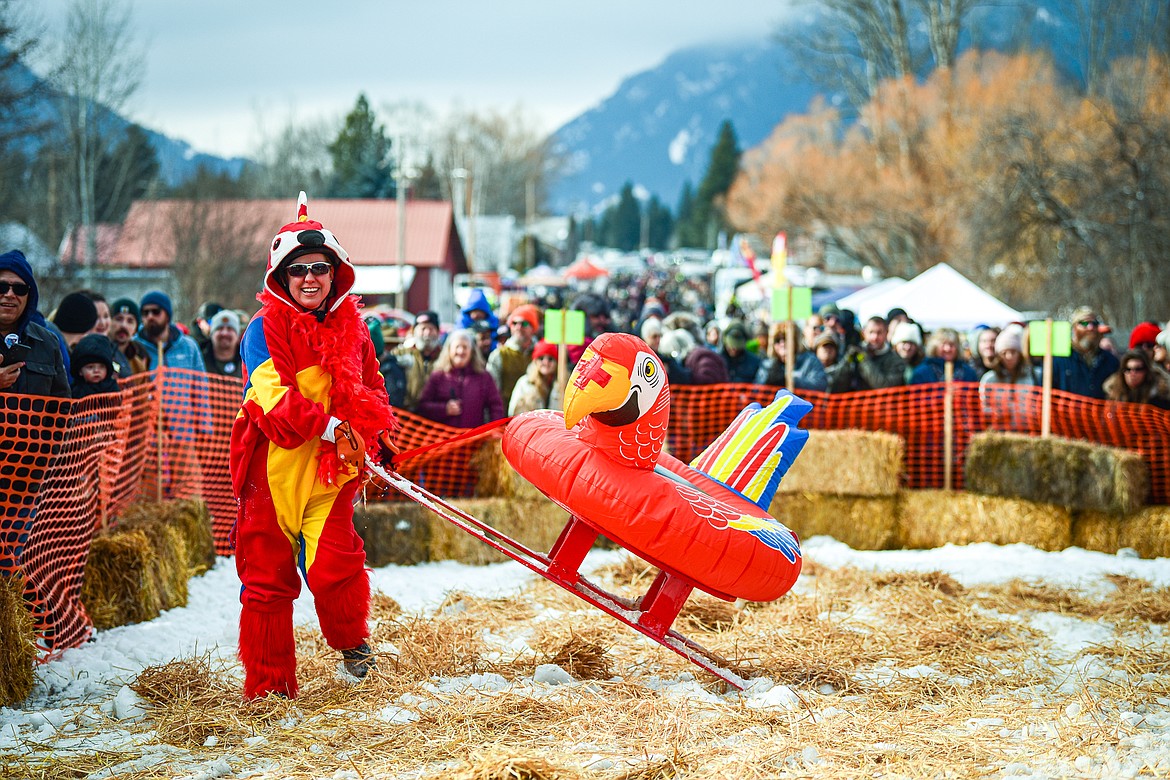 A participant pulls her barstool ski racer off the course after a race at the Barstool Ski Races at Cabin Fever Days in Martin City on Saturday, Feb. 10. (Casey Kreider/Daily Inter Lake)