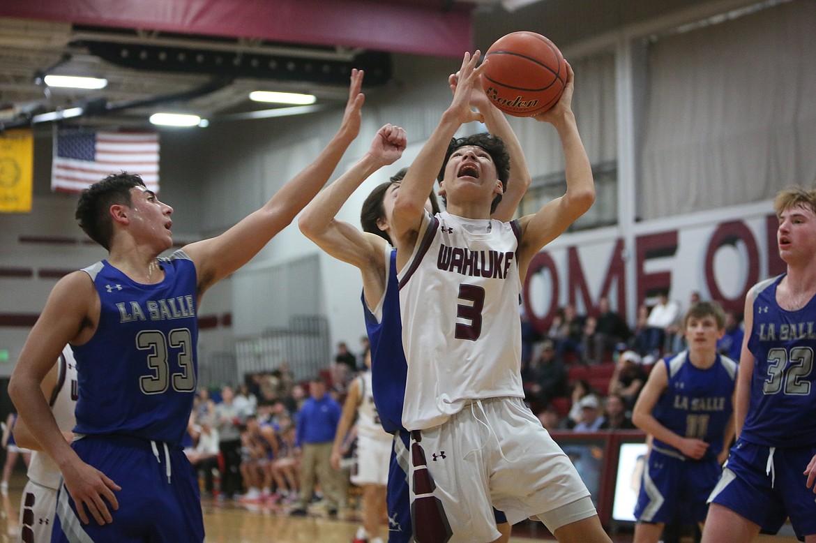 Wahluke freshman Manuel Ruvalcaba-Jimenez, in white, goes up to attempt a shot in the fourth quarter against La Salle on Thursday.