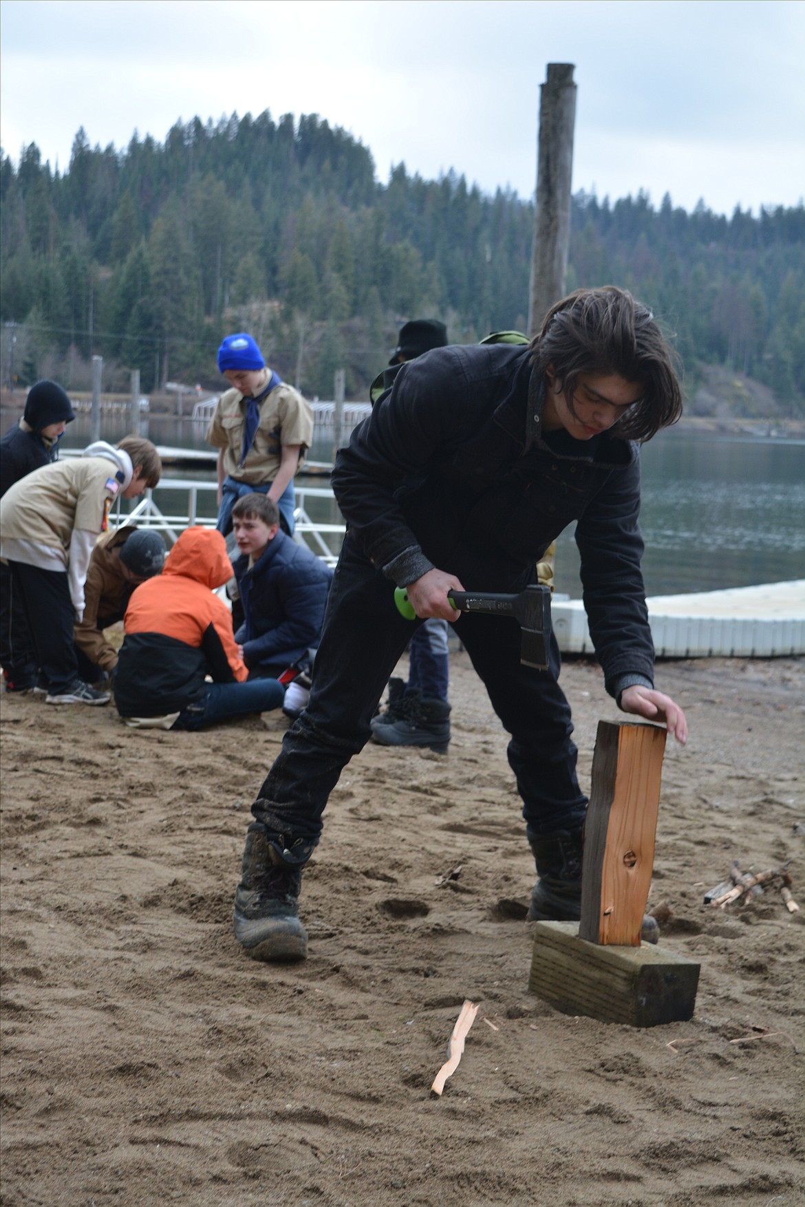 Jace Thompson chops wood during the Klondike Derby at Camp Easton.