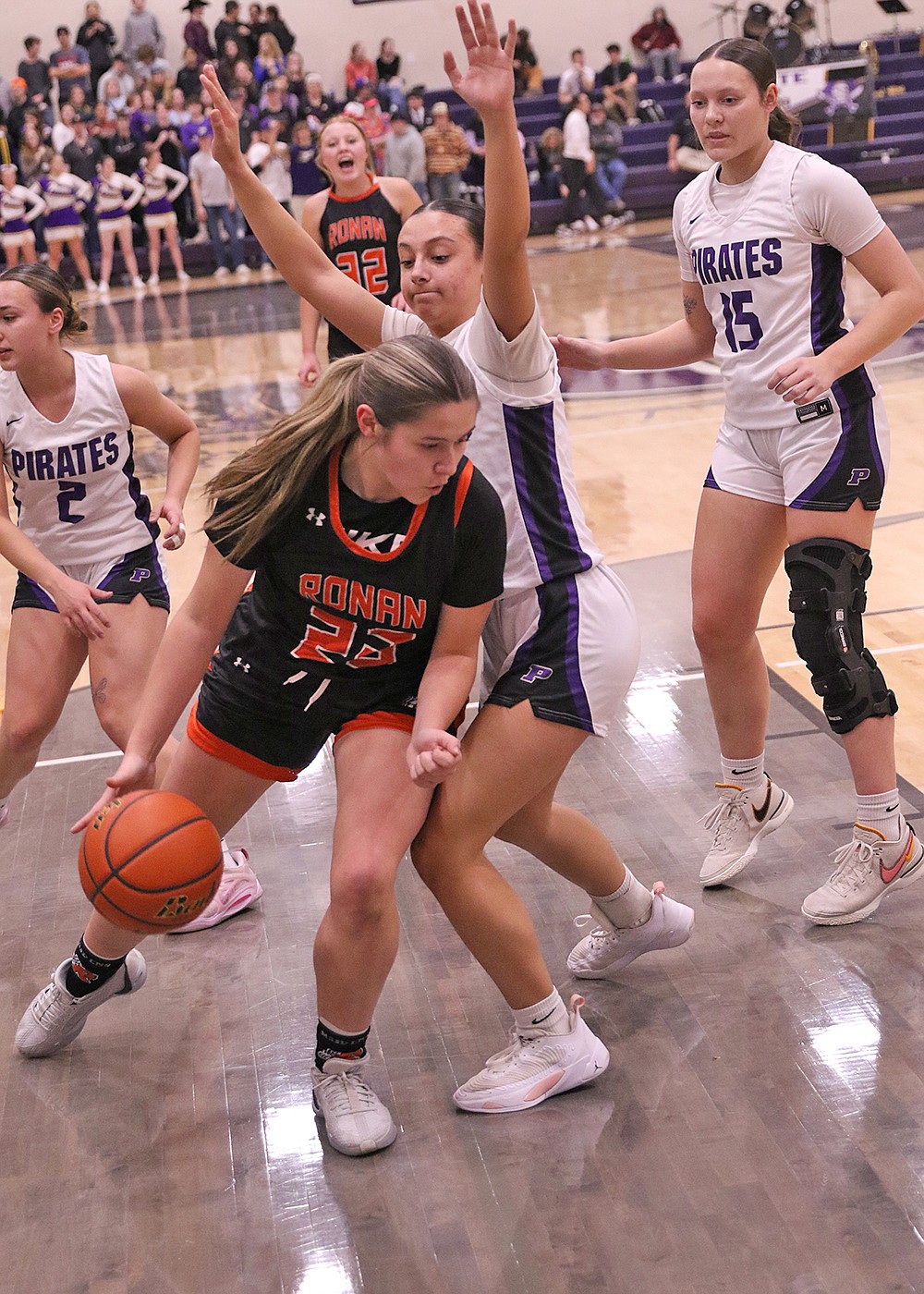 Maiden Zailee Hewankorn looks for a way around Lady Pirate Samantha Rensvold during Saturday's Senior Night game in Polson. (Bob Gunderson photo)