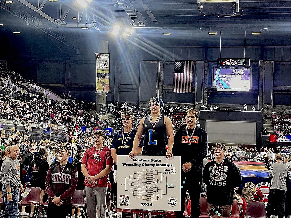 Libby senior Jace DeShazer stands atop the medal stand Saturday evening after winning his third straight Montana Class A wrestling championship. Classmate Marley Erickson also medaled at state. See more coverage in the Friday, Feb. 16 edition of The Western News. (Photo courtesy Libby High School)
