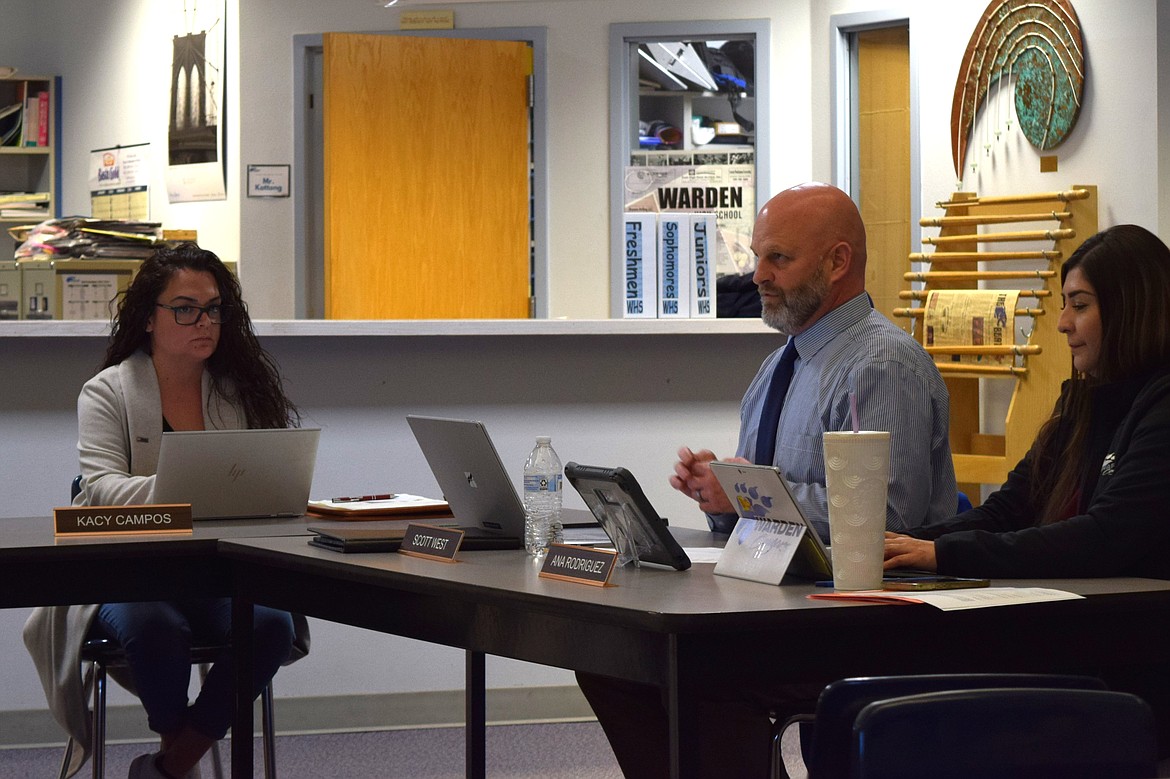 Warden School District Superintendent Scott West, middle, discusses the district’s increasing enrollment numbers and what that may mean for the district’s resources during Thursday’s regular Warden School Board meeting.