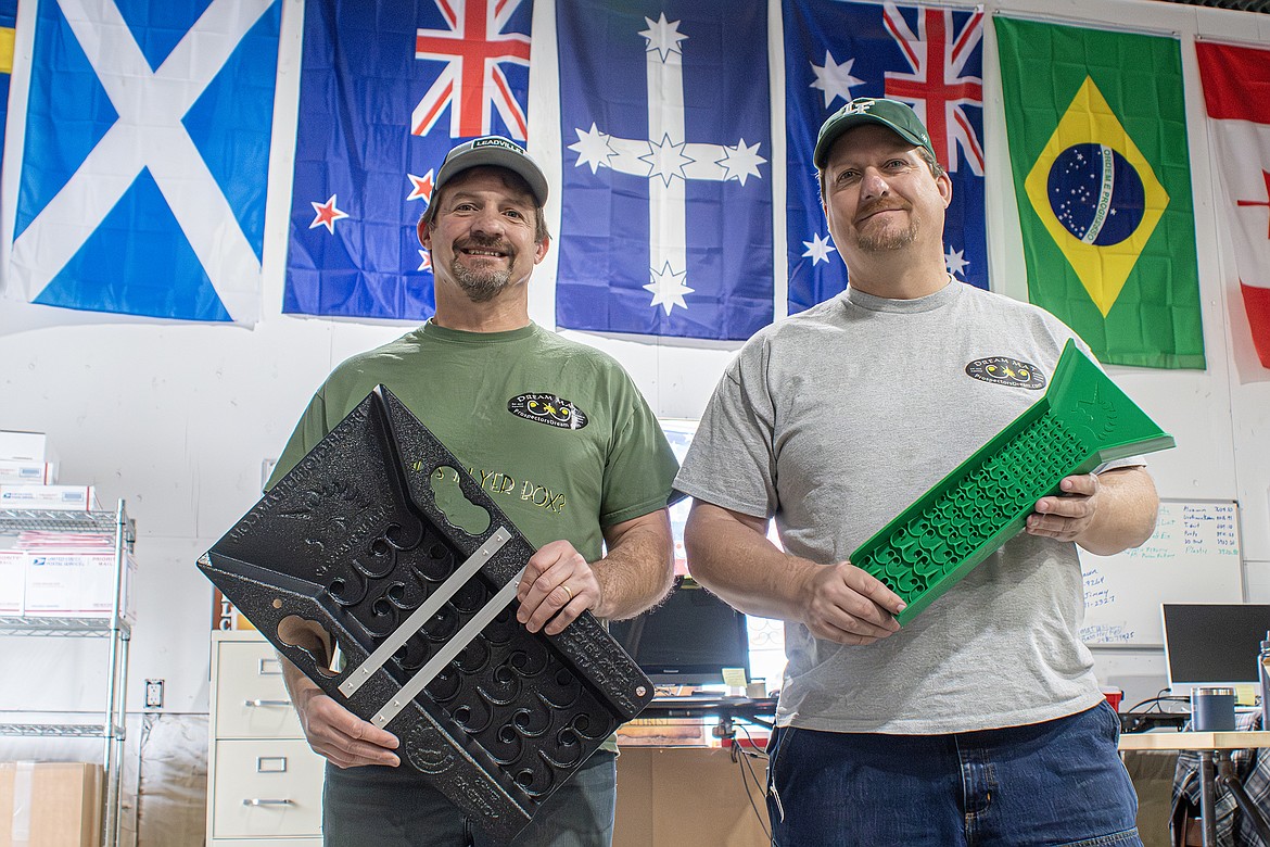 Brothers Tim and Dave Peterson show off their products in the Prospectors Dream shop off of Highway 206 on Feb. 1. The flags hanging behind them represent just some of the countries where Dream Mats are sold. (Avery Howe photo)