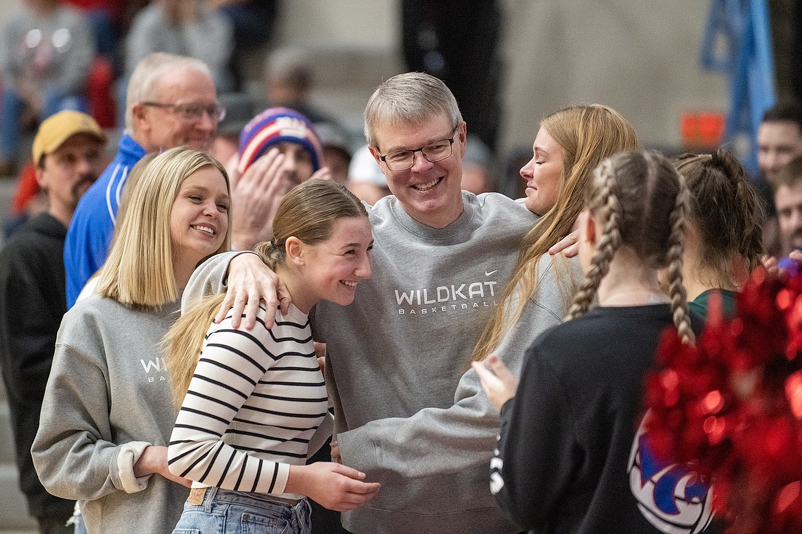 Left to right, assistant coach Ciera Finberg, Wildkat Madison Yerian, coach Cary Finberg and assistant coach Cydney Finberg-Roberts celebrate the coach’s last home game after a 28-season career at Columbia Falls High School Friday, Feb. 9. (Avery Howe photo)