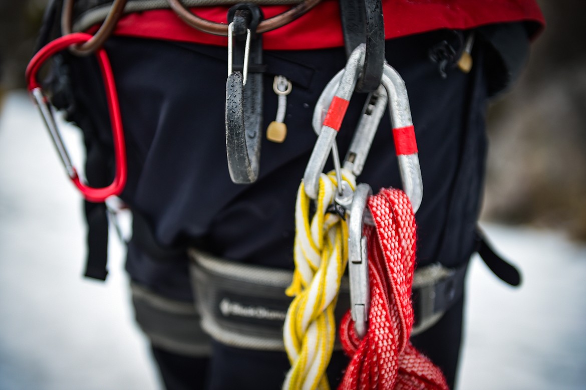 Carabiners and climbing ropes hang off of Dave Parker at Bad Rock Canyon on Saturday, Feb. 10. (Casey Kreider/Daily Inter Lake)