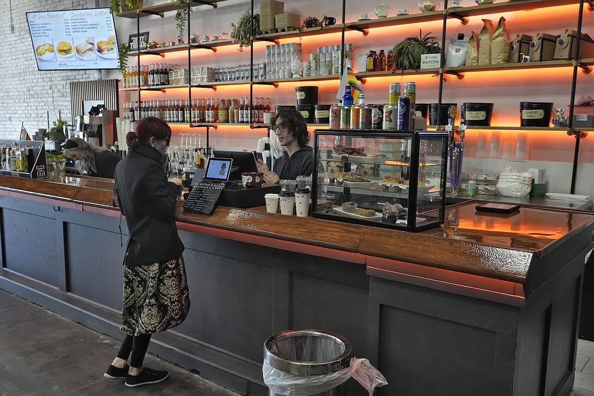 A customer buys a cup of coffee at the Blind Tiger Cafe on Jan. 10, 2024, in Tampa, Fla. On Tuesday, the Labor Department issues its report on inflation at the consumer level in January. (AP Photo/Chris O'Meara, File)