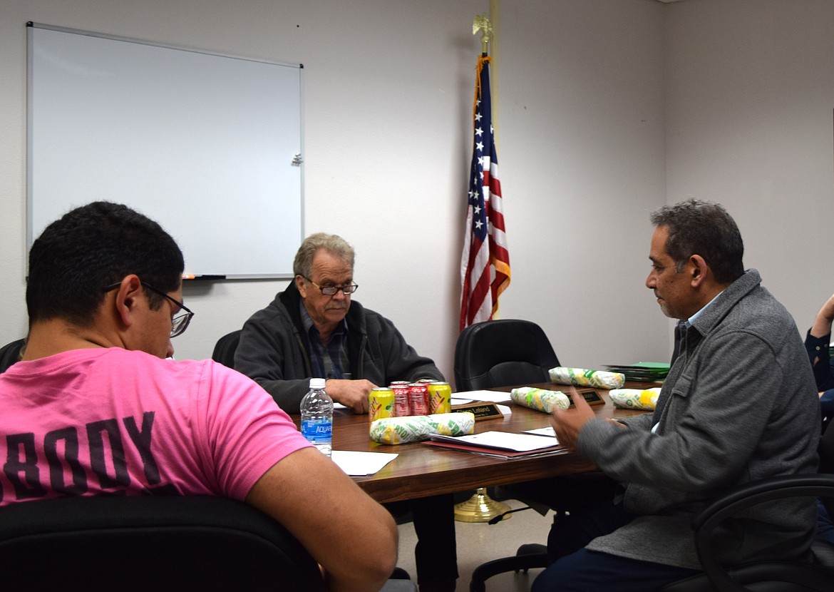 Port of Mattawa Maintenance Manager Daniel Martinez, left, Commissioner Glenn Leland, middle, and Executive Director Gil Alvarado, right, discuss port business during Monday’s regular meeting.