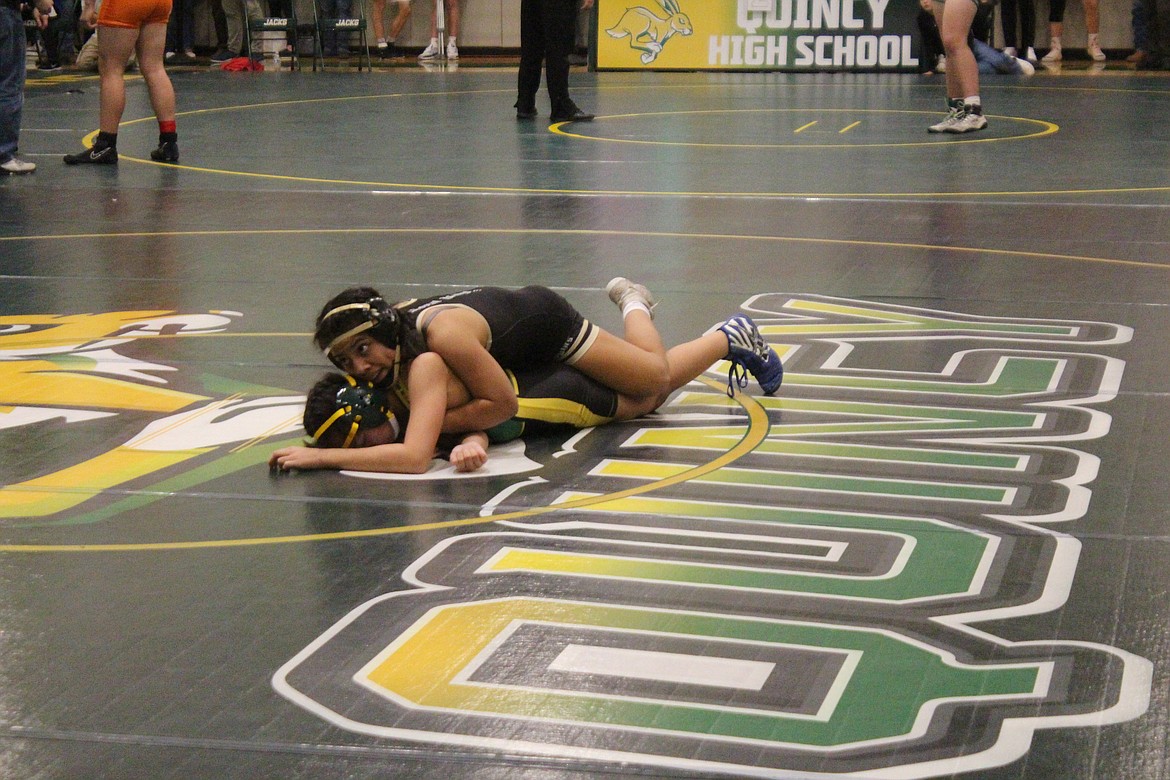 Sharon Arroyo, Royal, in black, works to turn her opponent during the Region 4 tournament in Quincy Saturday. Arroyo was the regional champion in the 100-pound class.