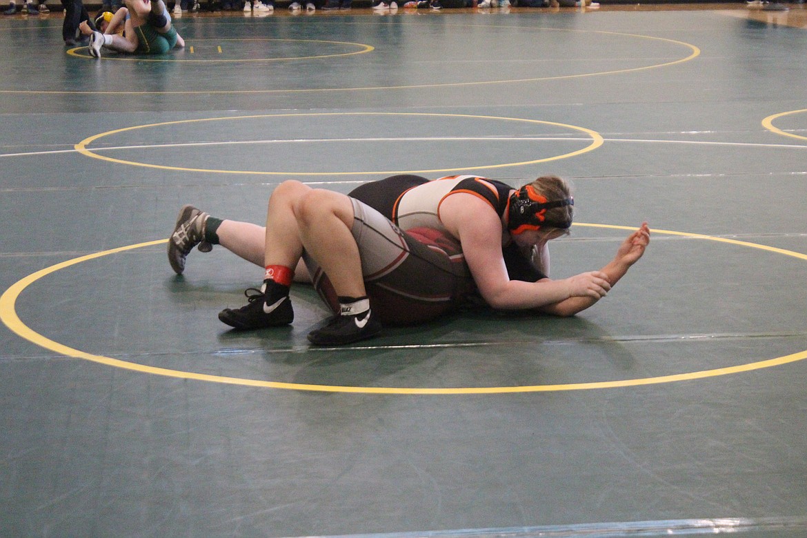 Region 4 champion Molly McMullen, in orange and black, almost has the pin.